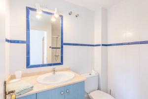 a bathroom with a sink and a toilet and a mirror at Veleta ll in Pollença +17 photos