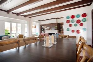 a dining room with a large wooden table and chairs at São Martinho All The Best in São Martinho do Porto