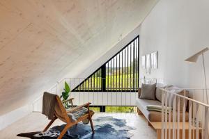 a living room with a couch and a chair at Ferienappartements Bayer in Sigmarszell
