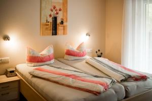 a bedroom with two beds with pillows on them at Paradies Im Schwarzwald in Bad Peterstal-Griesbach +45 photos