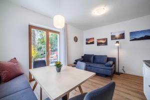 a living room with a couch and a table at Haus Hohenrain Ferienwohnung 1 in Schenna