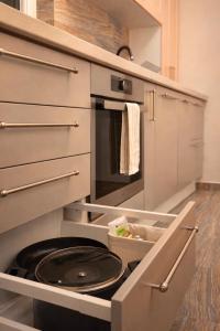 an open kitchen with a black stove in it at DG - Urban Stay in Floreşti +15 photos