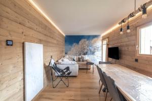a living room with wooden walls and a couch at Le Chappart - Carroz d'Arâches in Arâches-la-Frasse