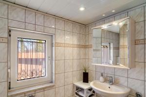 a bathroom with a sink and a window at Ferienhaus am Park in Heudeber +27 photos