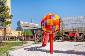 a colorful ball on a pole in a playground at Ferienhaus am Park in Heudeber
