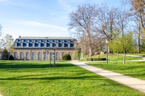 a large brick building with a sidewalk in front at Ferienhaus am Park in Heudeber