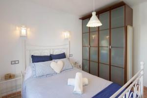 a bedroom with a bed with two hearts on it at Posidonia in Portocolom