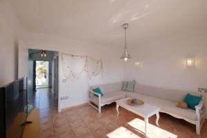 a living room with a couch and a table at Posidonia in Portocolom