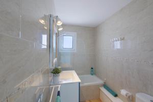 a bathroom with a sink and a bath tub at Posidonia in Portocolom +20 photos