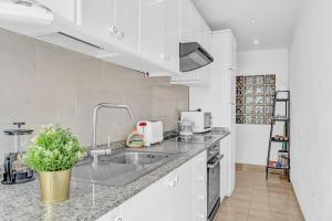 a kitchen with a sink and a counter top at Coqueto y tranquilo Apartamento in Puerto del Carmen +13 photos