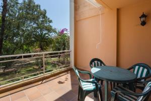 a balcony with a table and chairs and a window at Keops in Oliva