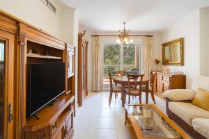 a living room with a tv and a table at Keops in Oliva