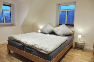 a bedroom with a bed with two pillows on it at Dat rode Huus in Oesterwurth