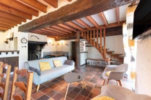 a living room with a couch and a staircase at Au Milan D'ore - Pyrénées in Gère-Belesten