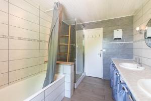 a bathroom with a tub and a sink and a shower at Au Milan D'ore - Pyrénées in Gère-Belesten +15 photos