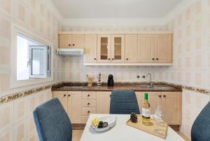 a kitchen with a table and chairs and a sink at La Casa de Tina in Playa de San Juan +25 photos