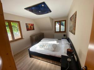 a bedroom with a large bed with a ceiling at Gästehaus Brigitte Schoch in Bad Rippoldsau-Schapbach +41 photos