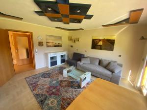 a living room with a couch and a table at Gästehaus Brigitte Schoch in Bad Rippoldsau-Schapbach