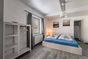 a bedroom with a bed and a window at Das weiße Stadthaus in Wesselburen