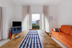 a living room with a wooden table and a couch at Montemare in Ameglia