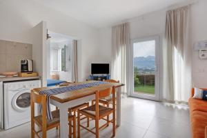 a kitchen with a table and chairs and a laundry room at Montemare in Ameglia