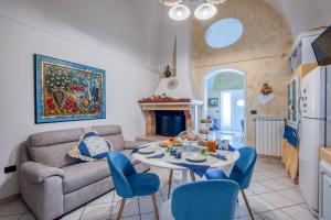 a living room with a couch and a table and chairs at Il Geco in Salice Salentino