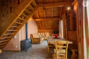 a room with a table and chairs and a staircase at La Gelinotte - Jarrier in Jarrier +2 photos