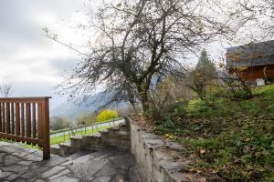 a wooden bench sitting next to a stone wall at La Gelinotte - Jarrier in Jarrier