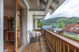 a balcony with a table and a view of the mountains at Haus Michler in Todtnau