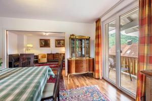 a living room with a table and a balcony at Haus Michler in Todtnau +47 photos