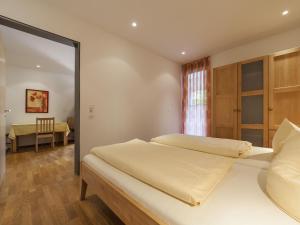 a bedroom with a large bed and a mirror at Ferienwohnung Kobl in Immenstaad am Bodensee