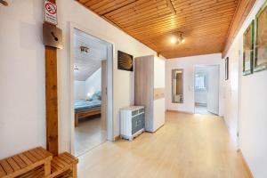 a hallway with a room with a bed and a wooden ceiling at Ferienwohnung Fly in Wehr