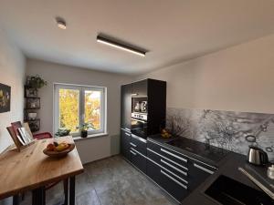 a kitchen with a counter and a table in it at Fewo Dandelion in Haag