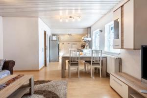a kitchen and living room with a table and chairs at Ferienwohnung Fly in Wehr