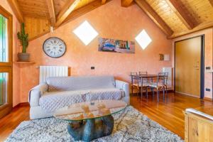 a living room with a couch and a table at Lovely Orange House in Viggiù