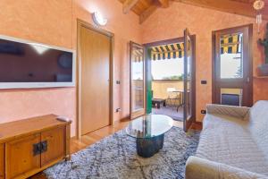 a living room with a couch and a table at Lovely Orange House in Viggiù +5 photos