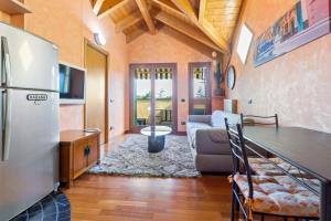 a kitchen and a living room with a refrigerator at Lovely Orange House in Viggiù