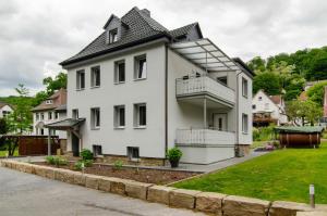 a white house with a black roof at Ferienhaus Berger 2025 in Bad Karlshafen