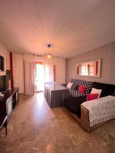 a living room with a couch and a table at La Casa Del Buda in Güéjar-Sierra