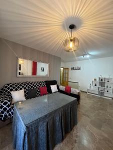 a living room with a couch and a table at La Casa Del Buda in Güéjar-Sierra