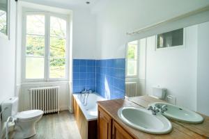 a bathroom with a sink and a toilet and a tub at Maison Etxeparea in Ustaritz +26 photos