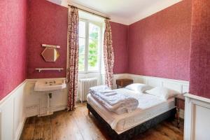 a bedroom with a bed and a sink and a window at Maison Etxeparea in Ustaritz