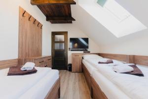 a room with two beds and a tv in it at Villa Jizbička in Náchod