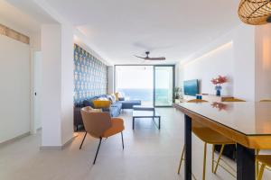 a kitchen and living room with a view of the ocean at Los acantilados in Almería