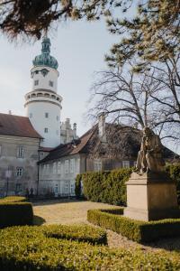 a statue in front of a building with a lighthouse at Villa Jizbička in Náchod