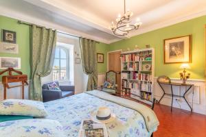 a bedroom with a bed and a book shelf at Appart face au Palais des Papes in Avignon