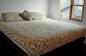 a bed sitting in a room with a window at Triggerplant 3 in Dinner Plain