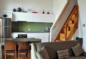 a living room with a couch and a table and a kitchen at Triggerplant 3 in Dinner Plain