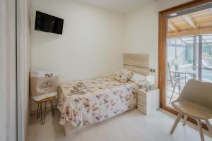 a bedroom with a bed and a table and a window at La Costana De Barbadillo in Barbadillo del Mercado +26 photos