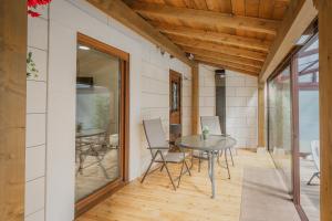 a room with a table and chairs on a patio at La Costana De Barbadillo in Barbadillo del Mercado